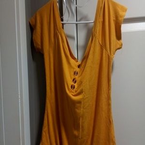 A mustard off-the-shoulder bodysuit